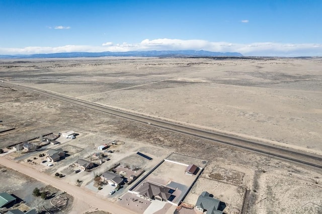 birds eye view of property with a desert view and a mountain view