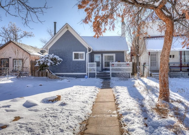 view of front of property with fence and stucco siding