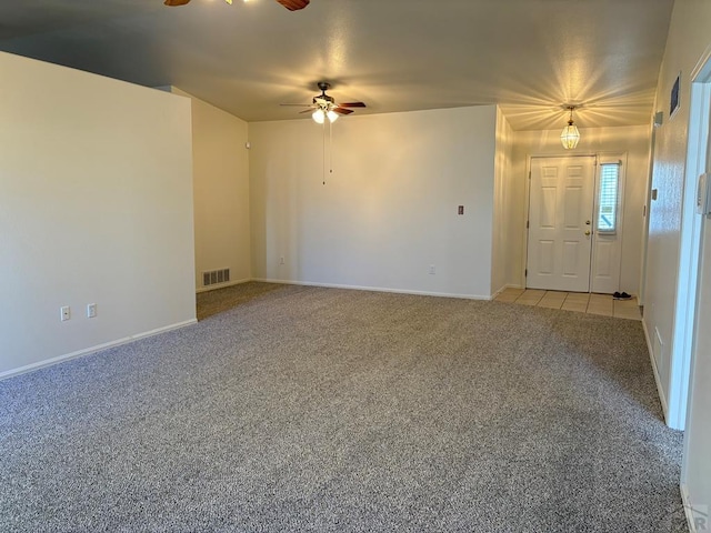 unfurnished living room with light colored carpet, ceiling fan, baseboards, and visible vents