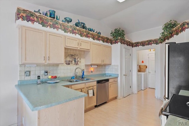 kitchen featuring separate washer and dryer, appliances with stainless steel finishes, a sink, decorative backsplash, and light brown cabinets