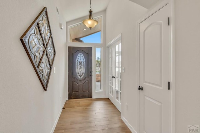 entryway featuring light wood-style flooring and baseboards