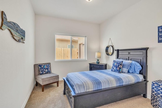 bedroom featuring baseboards and light colored carpet