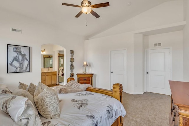 bedroom featuring arched walkways, visible vents, vaulted ceiling, and light carpet