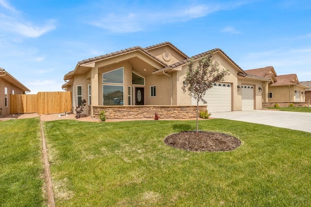 view of front of property featuring concrete driveway, a front yard, fence, a garage, and stone siding