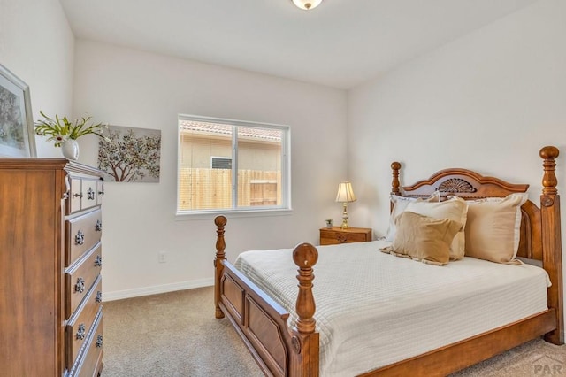 bedroom with light carpet and baseboards