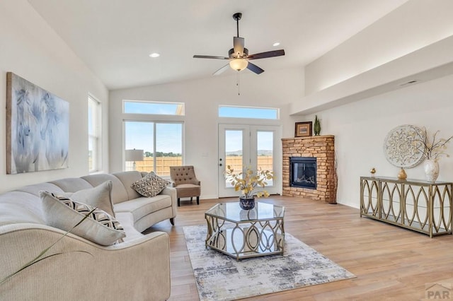 living room with recessed lighting, a ceiling fan, baseboards, light wood-style floors, and a glass covered fireplace