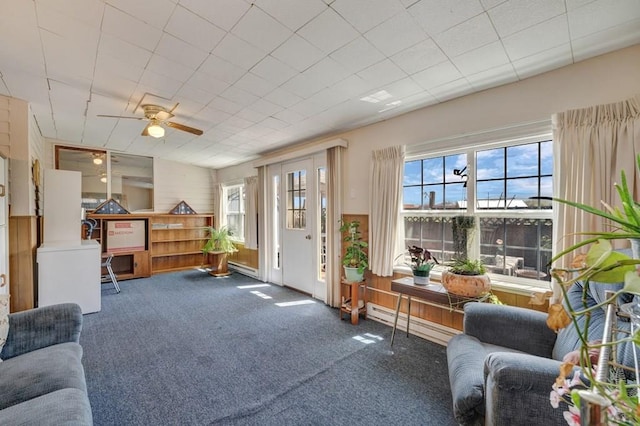 1104 Fairview Ave Unit A, Canon City, CO 81212 - living area featuring baseboard heating, plenty of natural light, carpet floors, ceiling fan, and wood walls