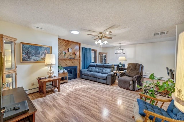1104 Fairview Ave Unit A, Canon City, CO 81212 - living area with a ceiling fan, a large fireplace, wood finished floors, wood walls, and a baseboard radiator