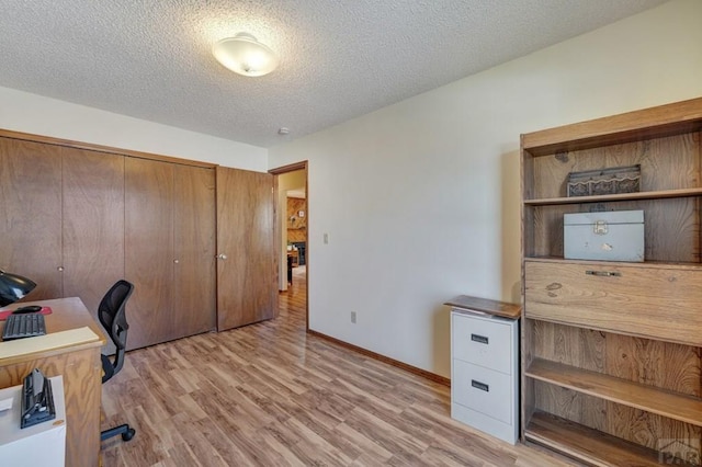 1104 Fairview Ave Unit A, Canon City, CO 81212 - unfurnished office with light wood-type flooring, a textured ceiling, and baseboards