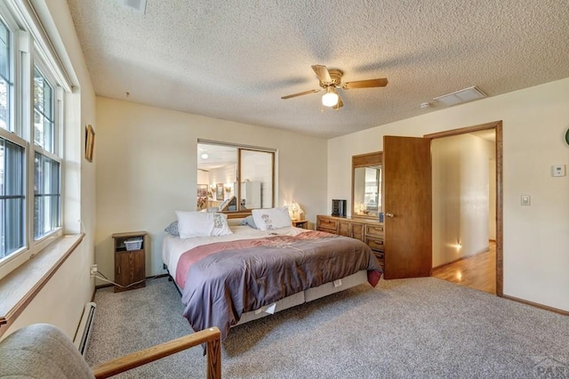 1104 Fairview Ave Unit A, Canon City, CO 81212 - carpeted bedroom featuring a baseboard radiator, a textured ceiling, a ceiling fan, and baseboards
