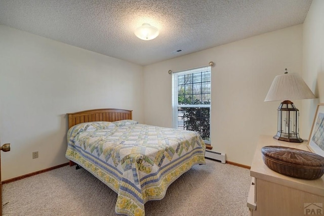 1104 Fairview Ave Unit A, Canon City, CO 81212 - bedroom with baseboard heating, light carpet, a textured ceiling, and baseboards