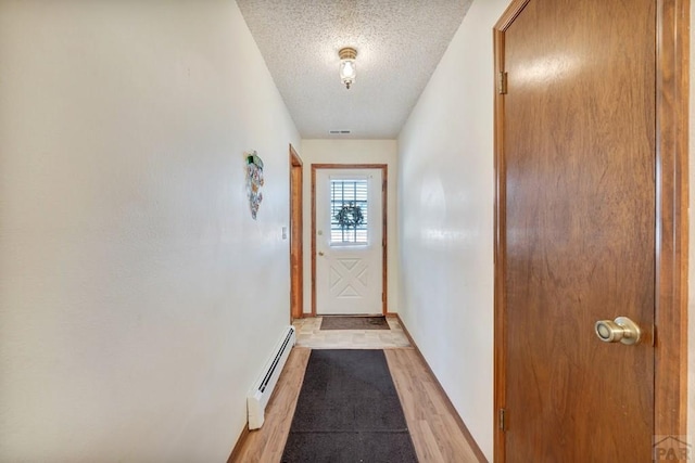 1104 Fairview Ave Unit A, Canon City, CO 81212 - entryway with a baseboard radiator, a textured ceiling, light wood-style floors, and baseboards