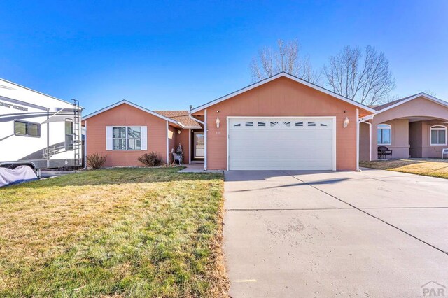 ranch-style home with a garage, concrete driveway, and a front yard