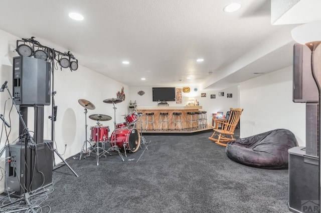 playroom featuring a textured ceiling, dark colored carpet, and recessed lighting