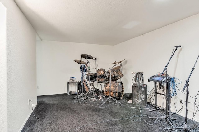 interior space with baseboards and dark carpet