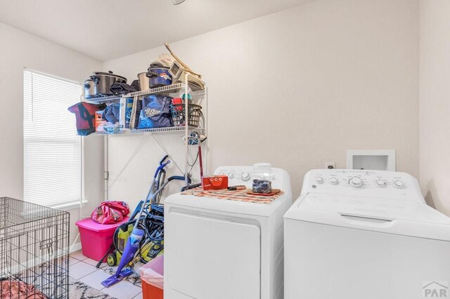 laundry room with washer and dryer, laundry area, and light tile patterned floors