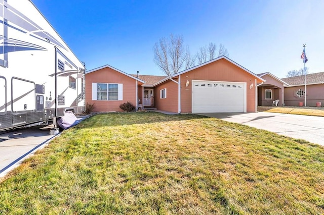 single story home featuring a garage, driveway, and a front lawn