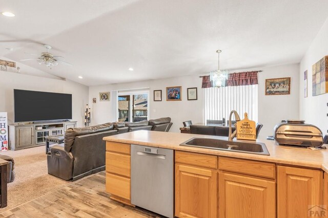 kitchen with open floor plan, light countertops, dishwasher, and a sink