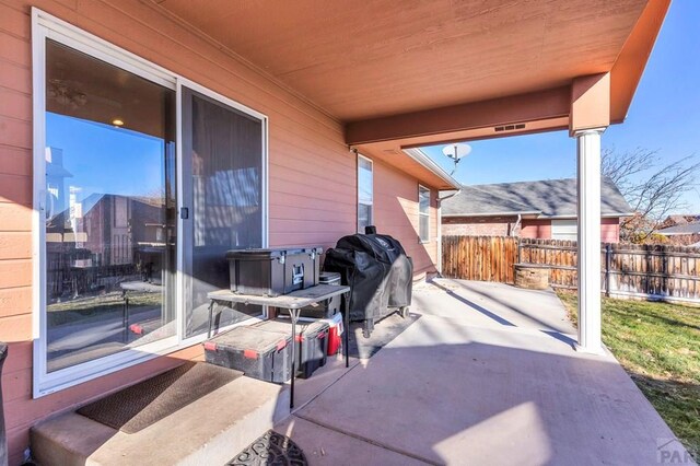 view of patio featuring fence and area for grilling