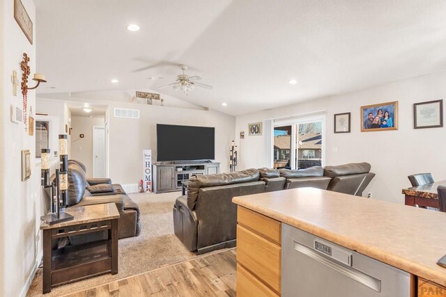 living room featuring visible vents, a ceiling fan, vaulted ceiling, light wood-style floors, and recessed lighting