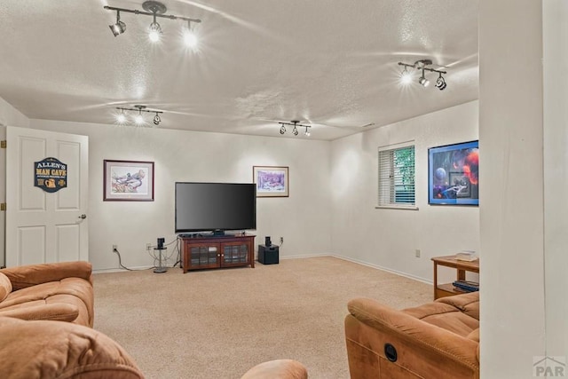 carpeted living area with a textured ceiling and baseboards