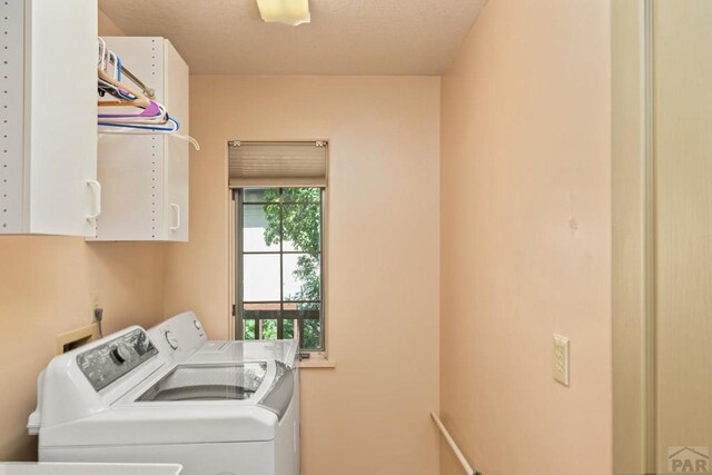 laundry room with cabinet space and washer and clothes dryer