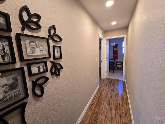 6190 Douglas Way, Colorado City, CO 81019 - corridor with baseboards, dark wood-style floors, a textured wall, and recessed lighting