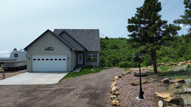6190 Douglas Way, Colorado City, CO 81019 - view of front facade featuring concrete driveway, an attached garage, roof with shingles, and stucco siding