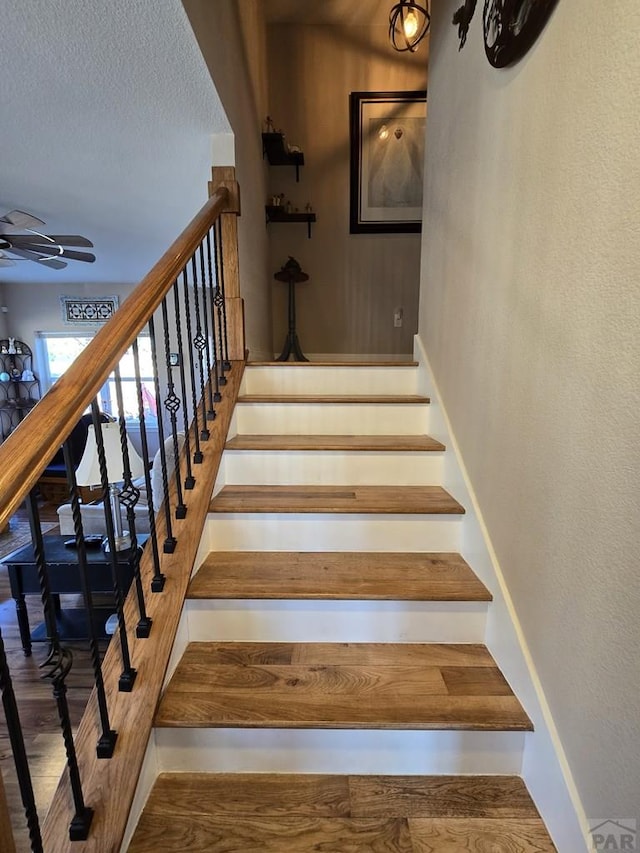 6190 Douglas Way, Colorado City, CO 81019 - stairway featuring a ceiling fan, baseboards, wood finished floors, and a textured ceiling
