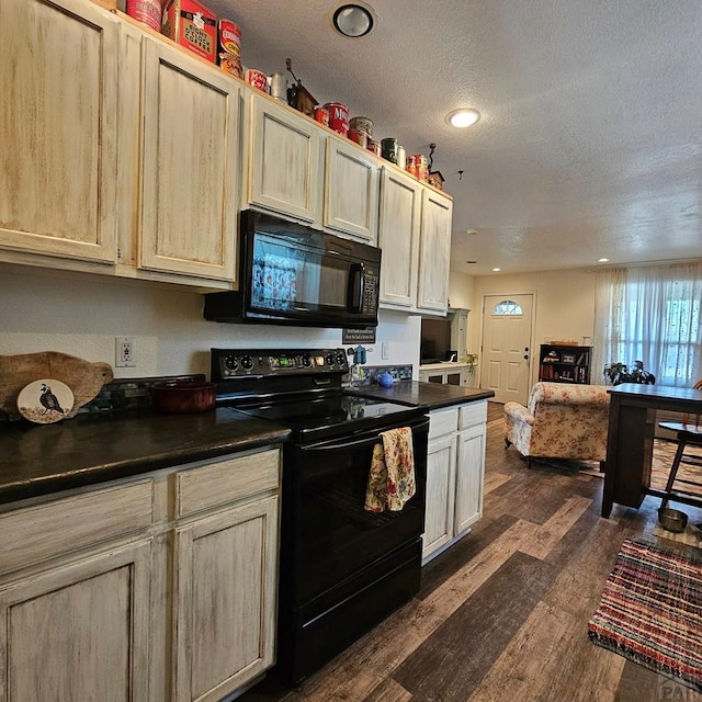 1819 W Arroyo Ave, Pueblo, CO 81004 - kitchen featuring black appliances, dark wood finished floors, dark countertops, a textured ceiling, and recessed lighting