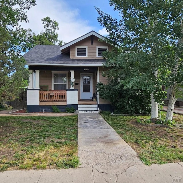 1819 W Arroyo Ave, Pueblo, CO 81004 - view of front of home with a porch, a front lawn, and a shingled roof
