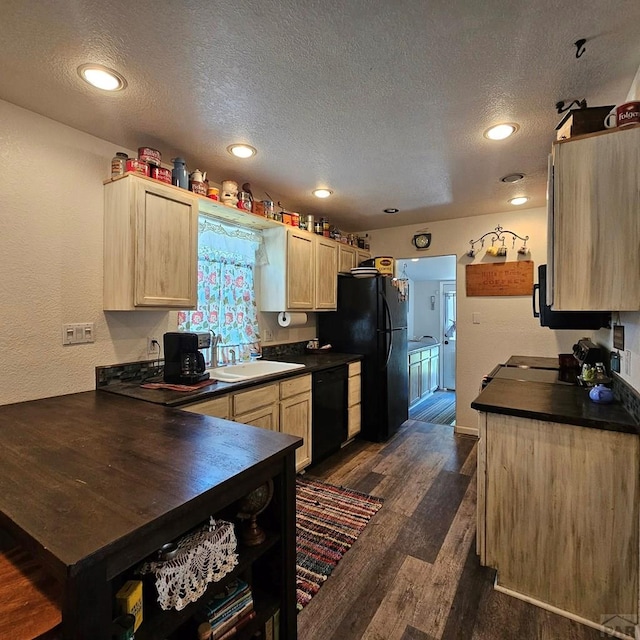 1819 W Arroyo Ave, Pueblo, CO 81004 - kitchen featuring black appliances, dark countertops, light brown cabinets, a textured ceiling, and dark wood-style floors