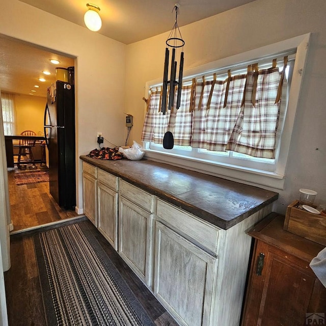 1819 W Arroyo Ave, Pueblo, CO 81004 - kitchen featuring dark countertops, freestanding refrigerator, and dark wood-type flooring