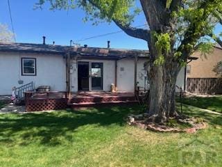 2013 Elmwood Ln, Pueblo, CO 81005 - rear view of house featuring a wooden deck and stucco siding