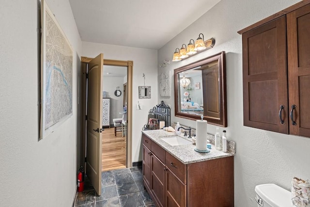 424 Mcclelland Ave, Pueblo, CO 81005 - bathroom with vanity, stone finish floors, and toilet