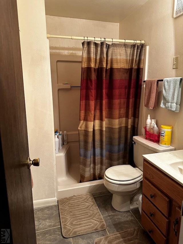 full bath featuring toilet, tile patterned floors, a shower stall, and vanity