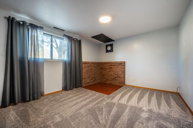 carpeted empty room with visible vents and baseboards