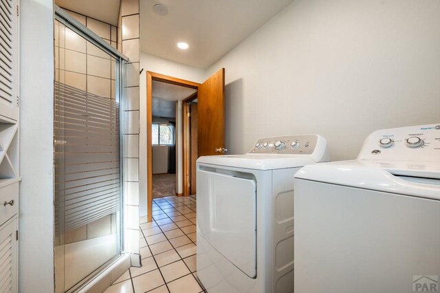 laundry area featuring laundry area, light tile patterned flooring, and separate washer and dryer