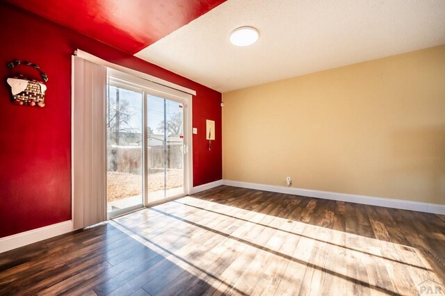 interior space featuring baseboards and wood finished floors