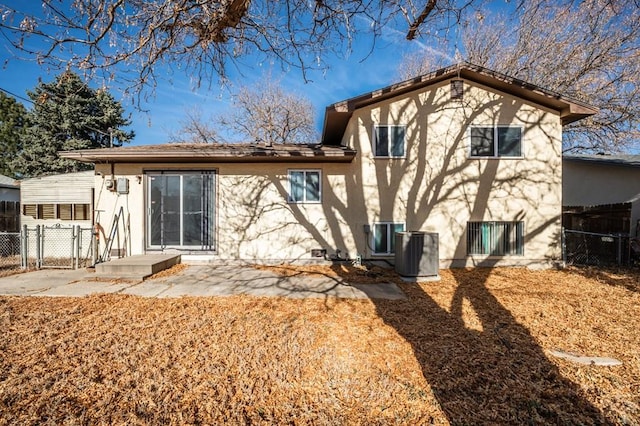 back of property featuring a patio area, cooling unit, fence, and stucco siding