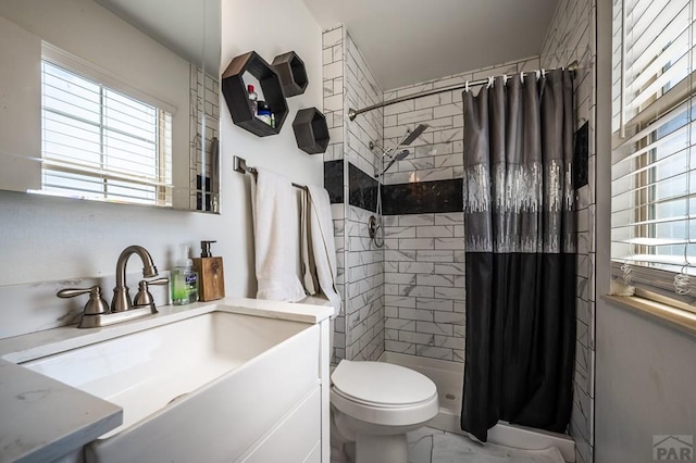 bathroom featuring marble finish floor, a shower stall, toilet, and vanity