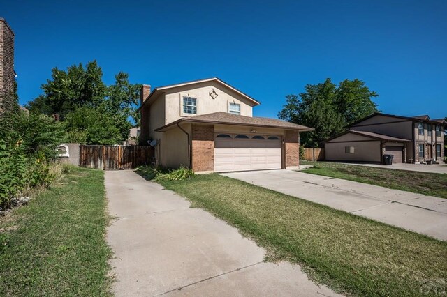 view of front of property with driveway, a front lawn, fence, and brick siding