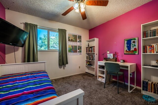 bedroom featuring baseboards, ceiling fan, dark carpet, and a textured ceiling