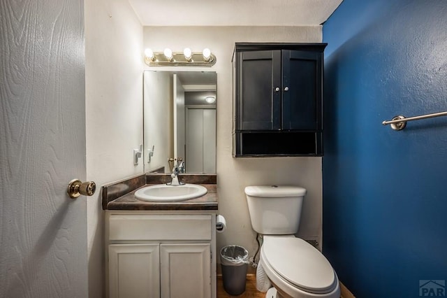 half bathroom featuring toilet and vanity