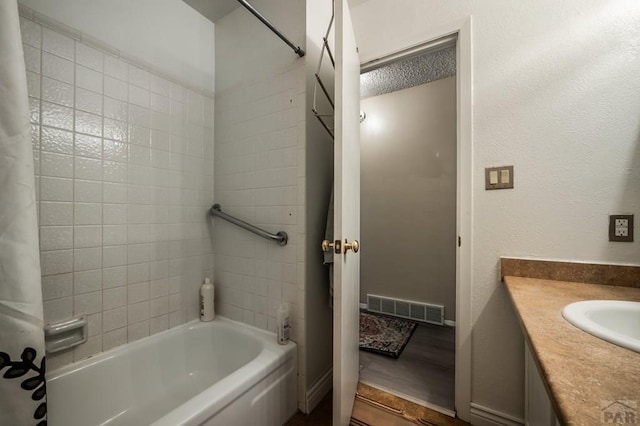 bathroom featuring visible vents, shower / tub combo with curtain, and vanity