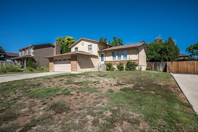 view of front of property featuring a garage, fence, driveway, a gate, and a chimney