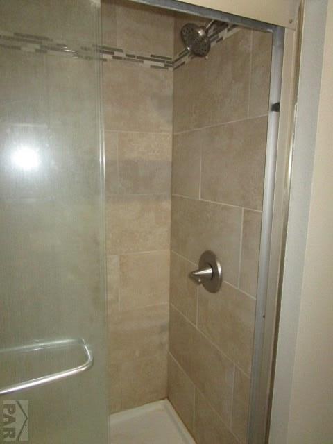 bathroom featuring a shower stall