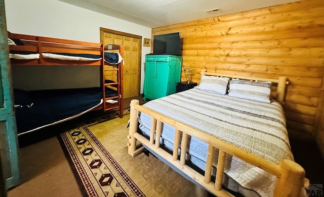 834 Ponderosa Rd, Cuchara, CO 81055 - bedroom with log walls and wood finished floors
