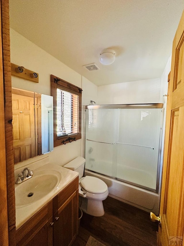 834 Ponderosa Rd, Cuchara, CO 81055 - bathroom featuring vanity, toilet, bath / shower combo with glass door, and wood finished floors