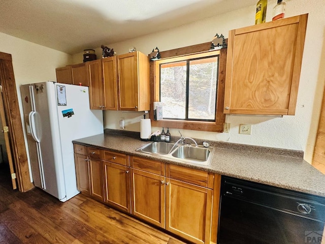 834 Ponderosa Rd, Cuchara, CO 81055 - kitchen featuring dishwasher, a sink, freestanding refrigerator, dark wood-type flooring, and brown cabinetry
